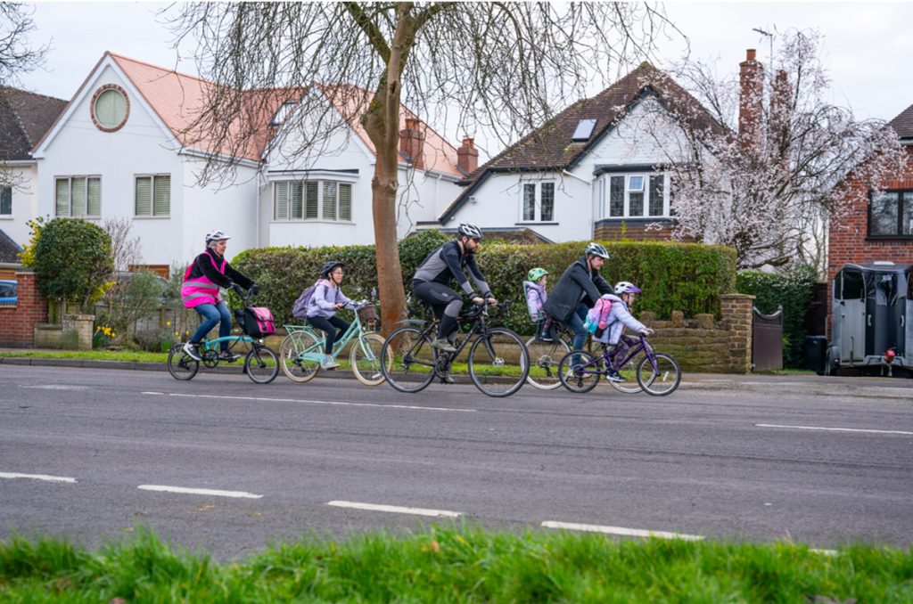 Annabel Precious – Director at The Transportation Consultancy (ttc), leading children on bikes down the road, on a school bike bus in warwickshire