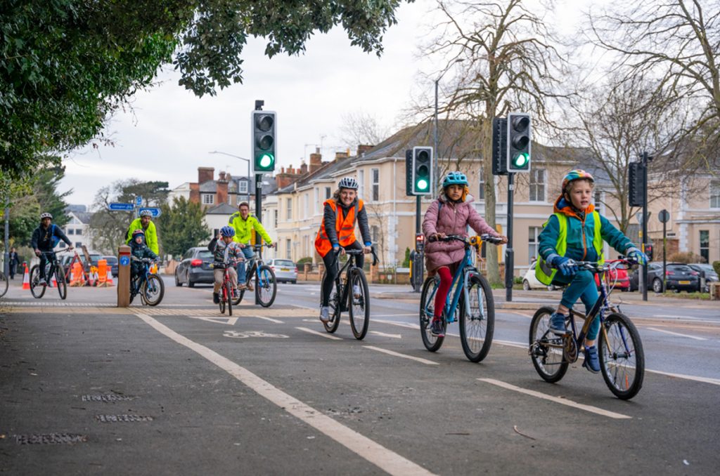 Annabel Precious – Director at The Transportation Consultancy (ttc), leading children on bikes down the road, on a school bike bus in warwickshire