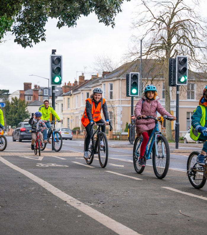 Annabel Precious – Director at The Transportation Consultancy (ttc), leading children on bikes down the road, on a school bike bus in warwickshire