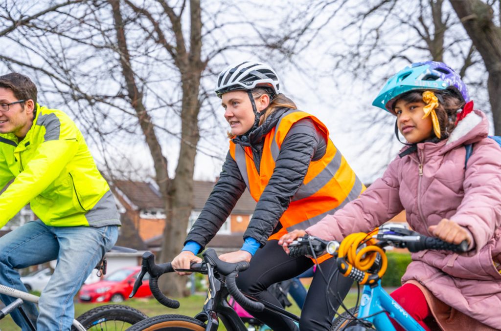 Annabel Precious – Director at The Transportation Consultancy (ttc), leading children on bikes down the road, on a school bike bus in warwickshire